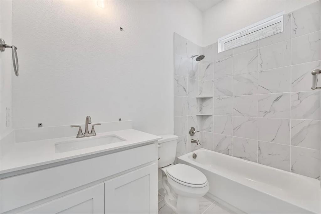 9337 Loggerhead Way Fort Worth, TX 76118 - Photo 7 of 40 a bathroom with a sink a toilet and shower