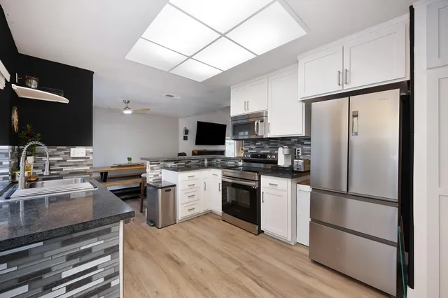 a view of an empty room with a window and closet