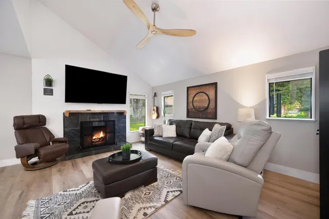 a living room with furniture and wooden floor