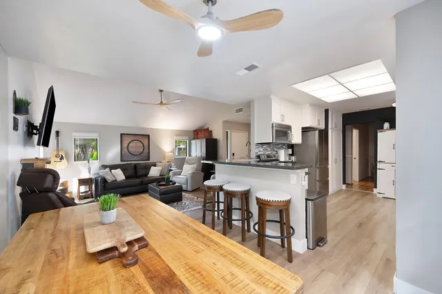 a bathroom with a granite countertop double vanity sink and a mirror