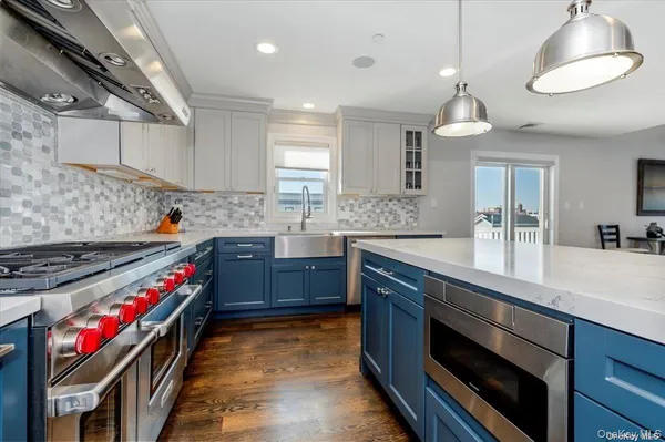a kitchen with stainless steel appliances granite countertop a stove a sink and a refrigerator