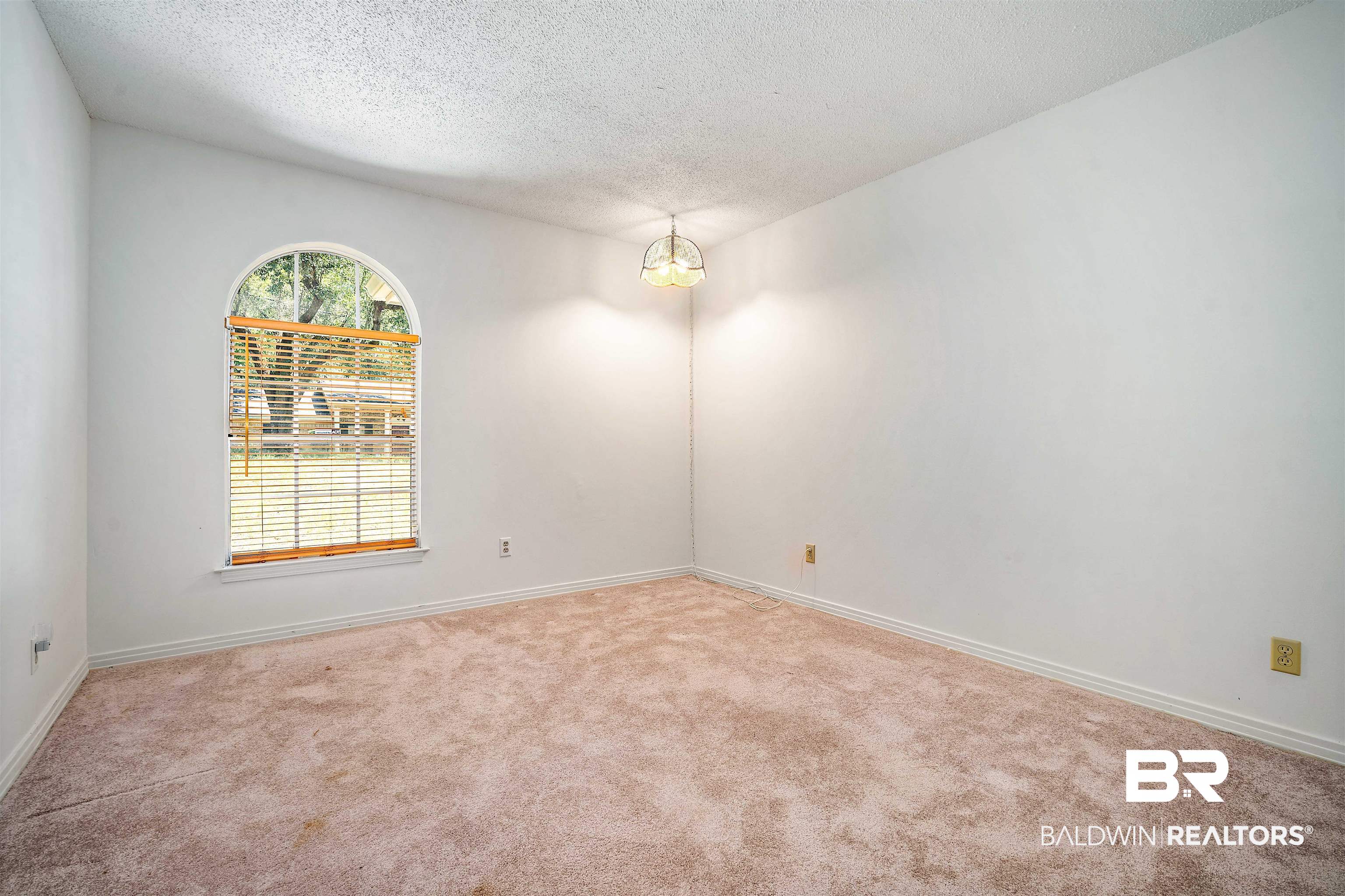 5559 Woodside Drive North Mobile, AL 36608 - Photo 5 of 28 Spare room with a textured ceiling and light colored carpet
