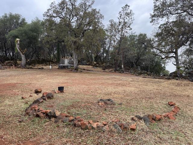 18288 Mountaintop Lane Grass Valley, CA 95949 - Photo 29 of 40 a view of a fire pit with large trees