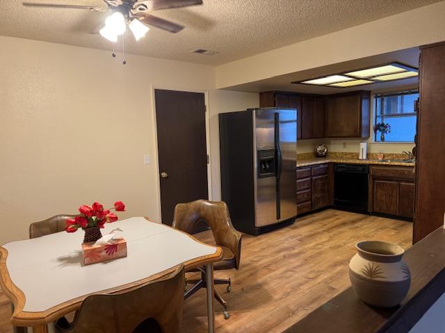 18288 Mountaintop Lane Grass Valley, CA 95949 - Photo 7 of 40 a kitchen with stainless steel appliances kitchen island granite countertop a dining table chairs and refrigerator