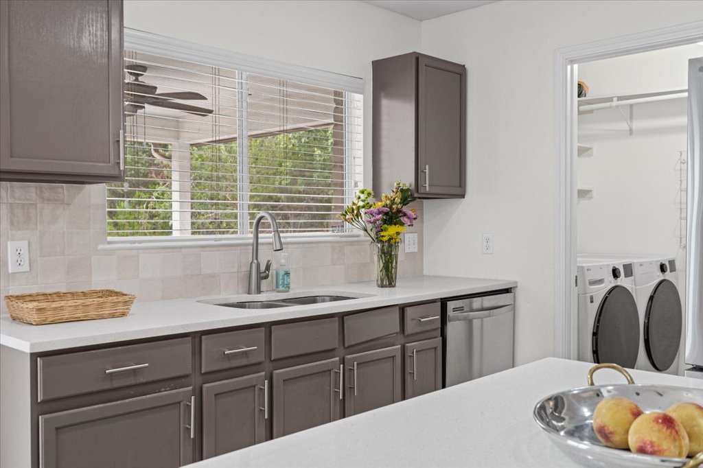 7451 Pusch Ridge Loop Austin, TX 78749 - Photo 11 of 26 A window overlooks the backyard from this functional kitchen space with adjacent laundry facilities.