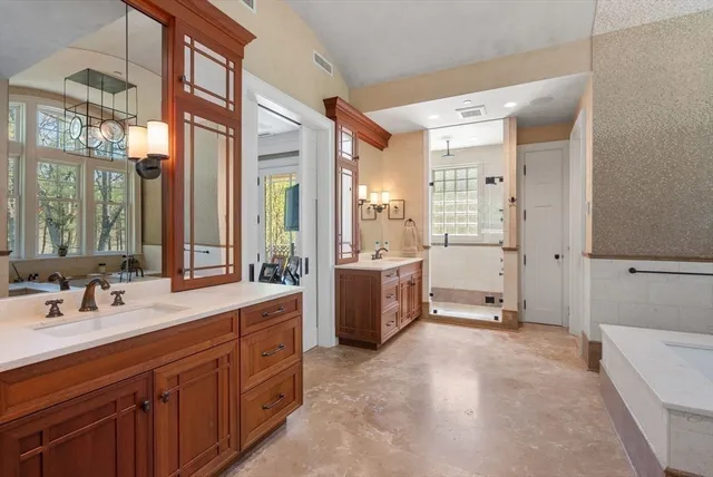 a spacious bathroom with a double vanity sink mirror and double