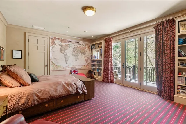 a bedroom with a large bed and a large window with wooden floor