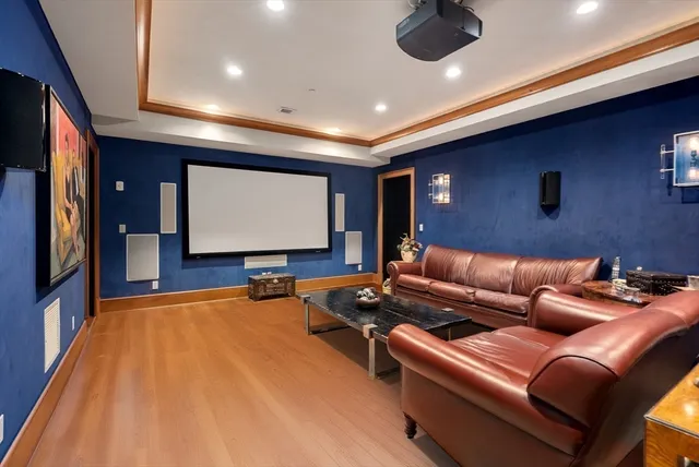 a room with furniture projector and screen