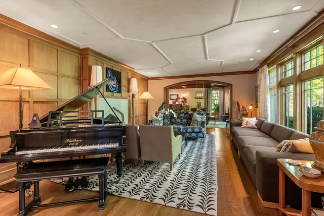a living room with furniture and a piano