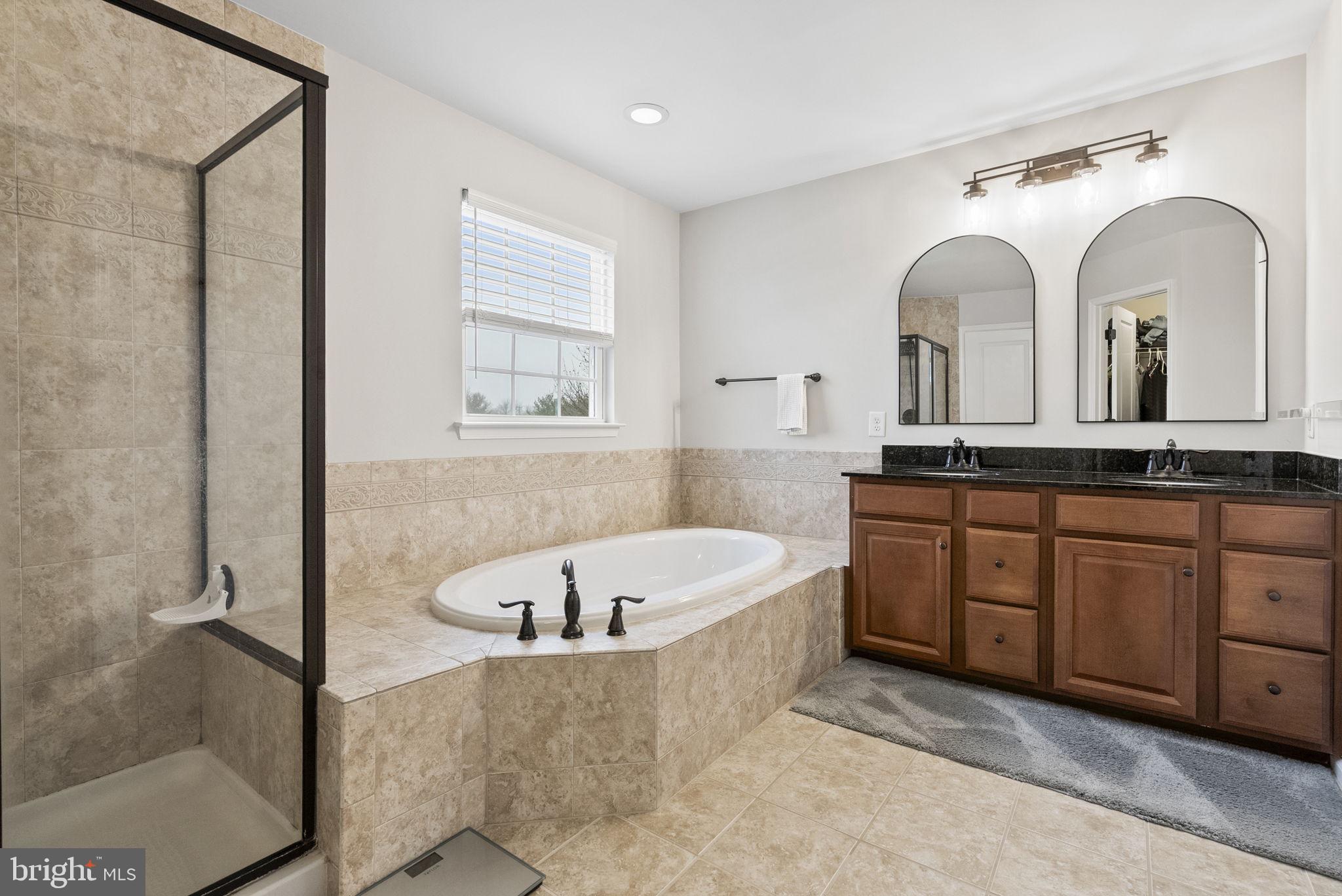 638 Bridge Street Spring City, PA 19475 - Photo 31 of 59 a spacious bathroom with a tub a double vanity sink and a mirror