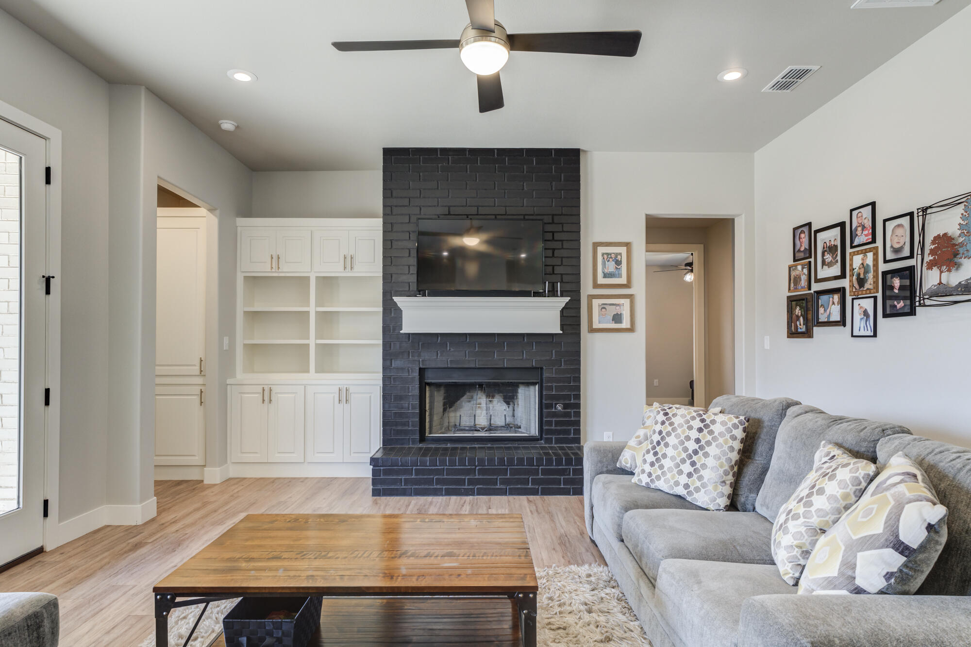 5611 117th Street Lubbock, TX 79424 - Photo 11 of 30 a living room with furniture and a fireplace