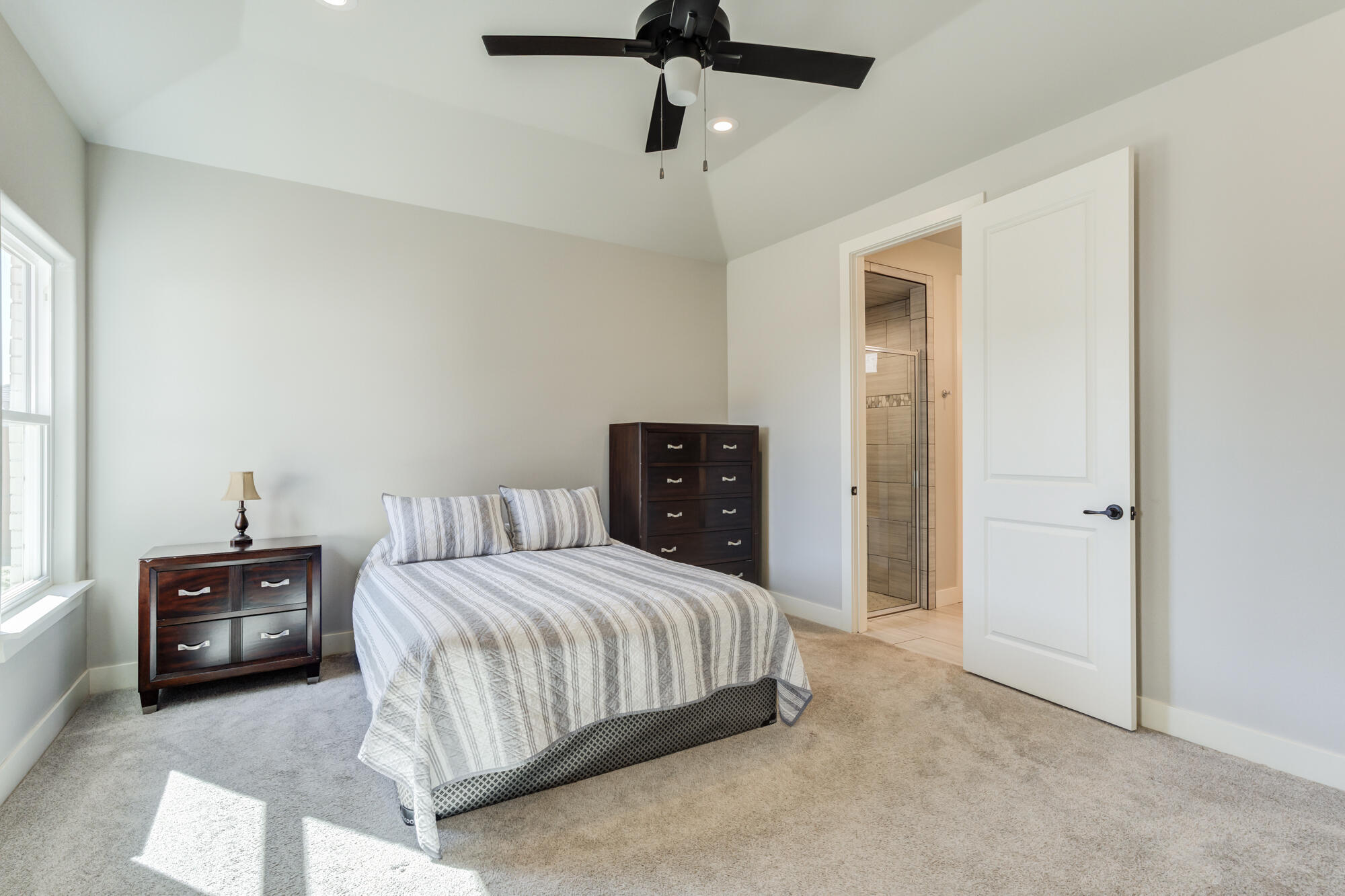 5611 117th Street Lubbock, TX 79424 - Photo 15 of 30 a bedroom with a bed and ceiling fan