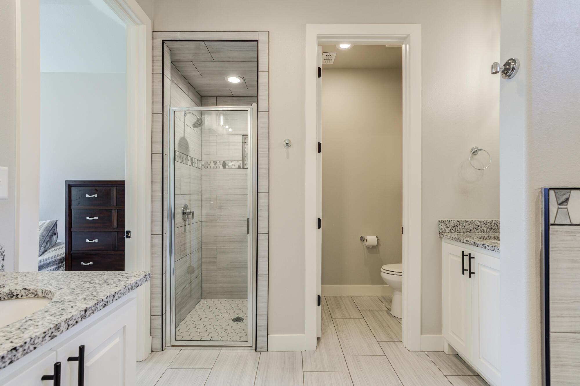 5611 117th Street Lubbock, TX 79424 - Photo 17 of 30 a bathroom with a granite countertop sink mirror and shower