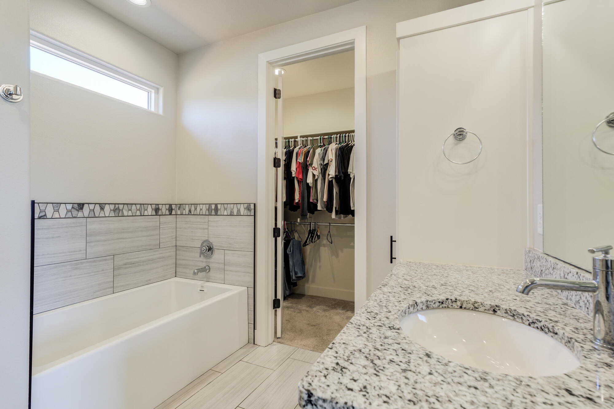 5611 117th Street Lubbock, TX 79424 - Photo 18 of 30 a bathroom with a tub sink and a mirror