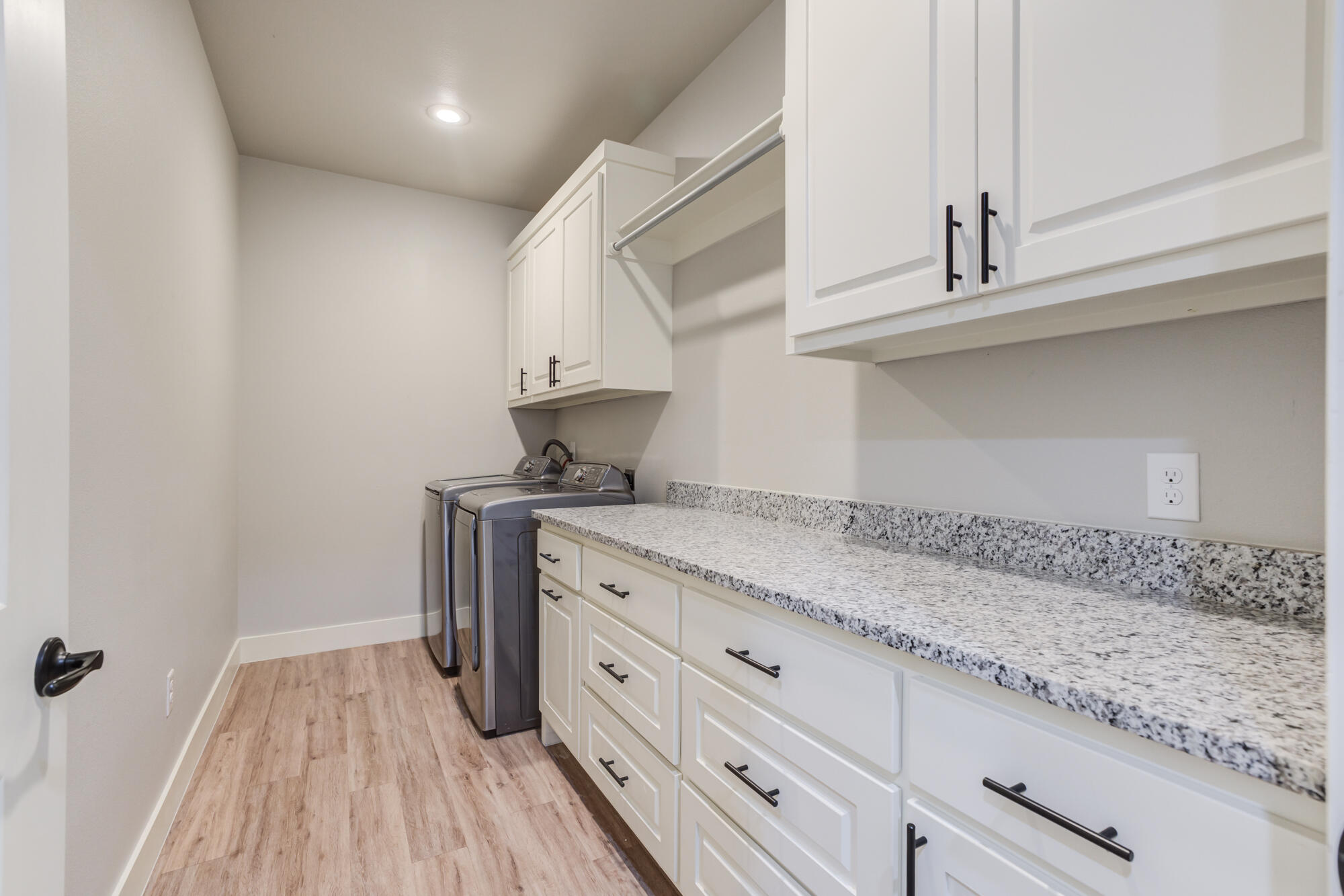 5611 117th Street Lubbock, TX 79424 - Photo 20 of 30 a kitchen with granite countertop white cabinets and white appliances