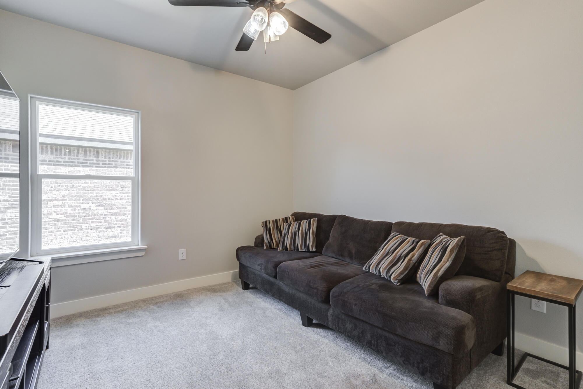5611 117th Street Lubbock, TX 79424 - Photo 22 of 30 a living room with furniture and a window