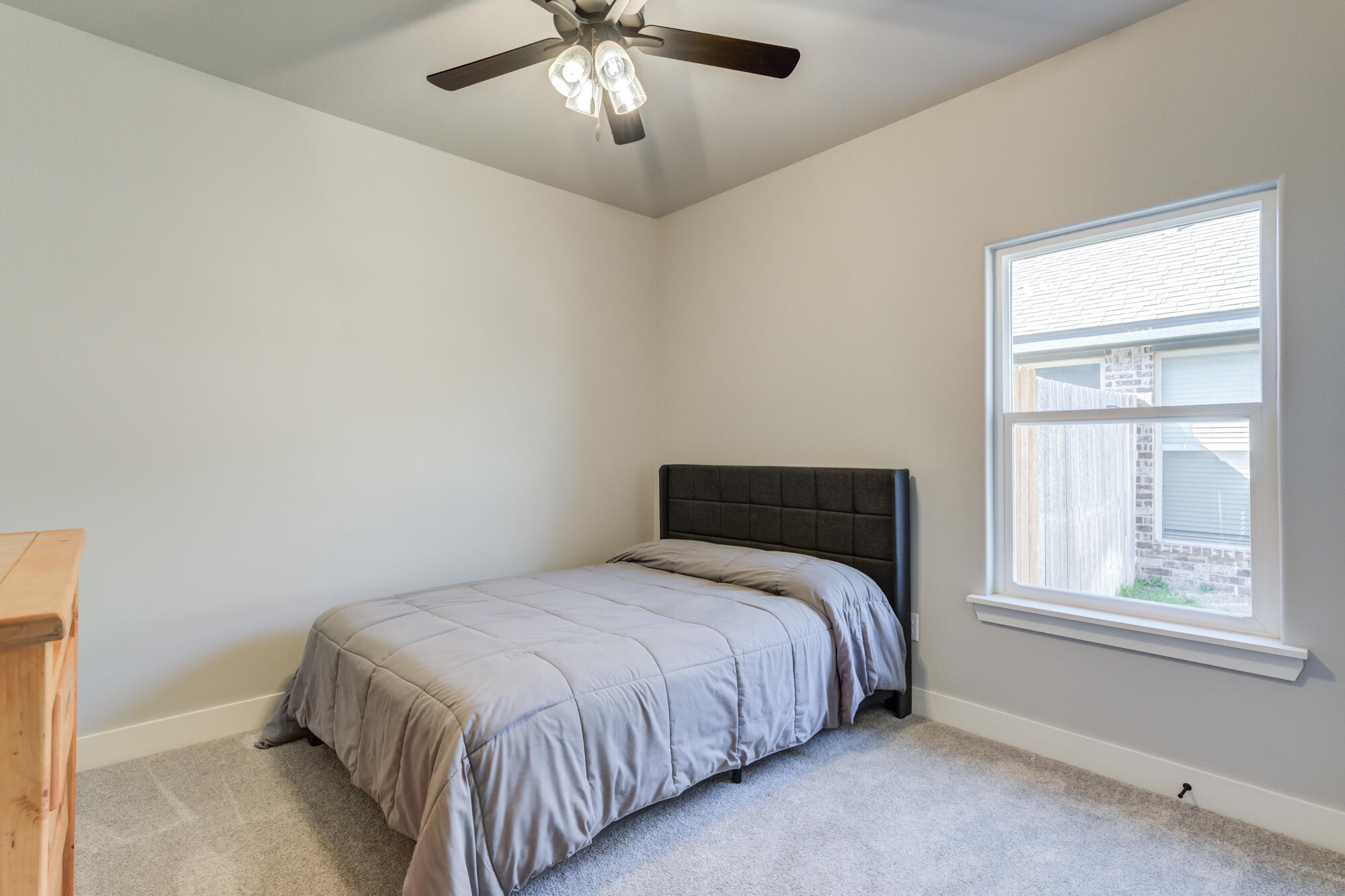 5611 117th Street Lubbock, TX 79424 - Photo 23 of 30 a bedroom with a bed and window