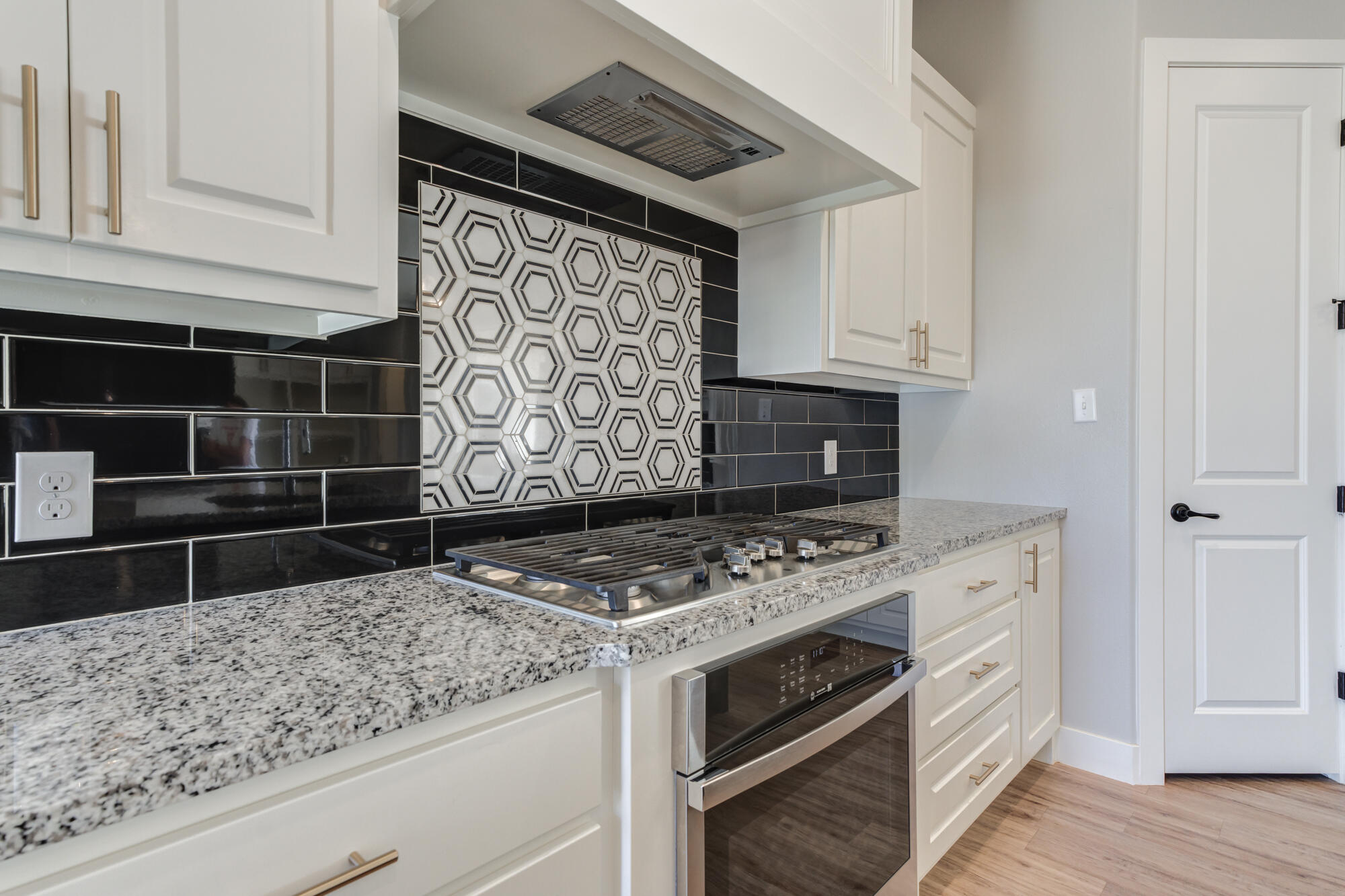 5611 117th Street Lubbock, TX 79424 - Photo 8 of 30 a kitchen with granite countertop a stove and cabinets