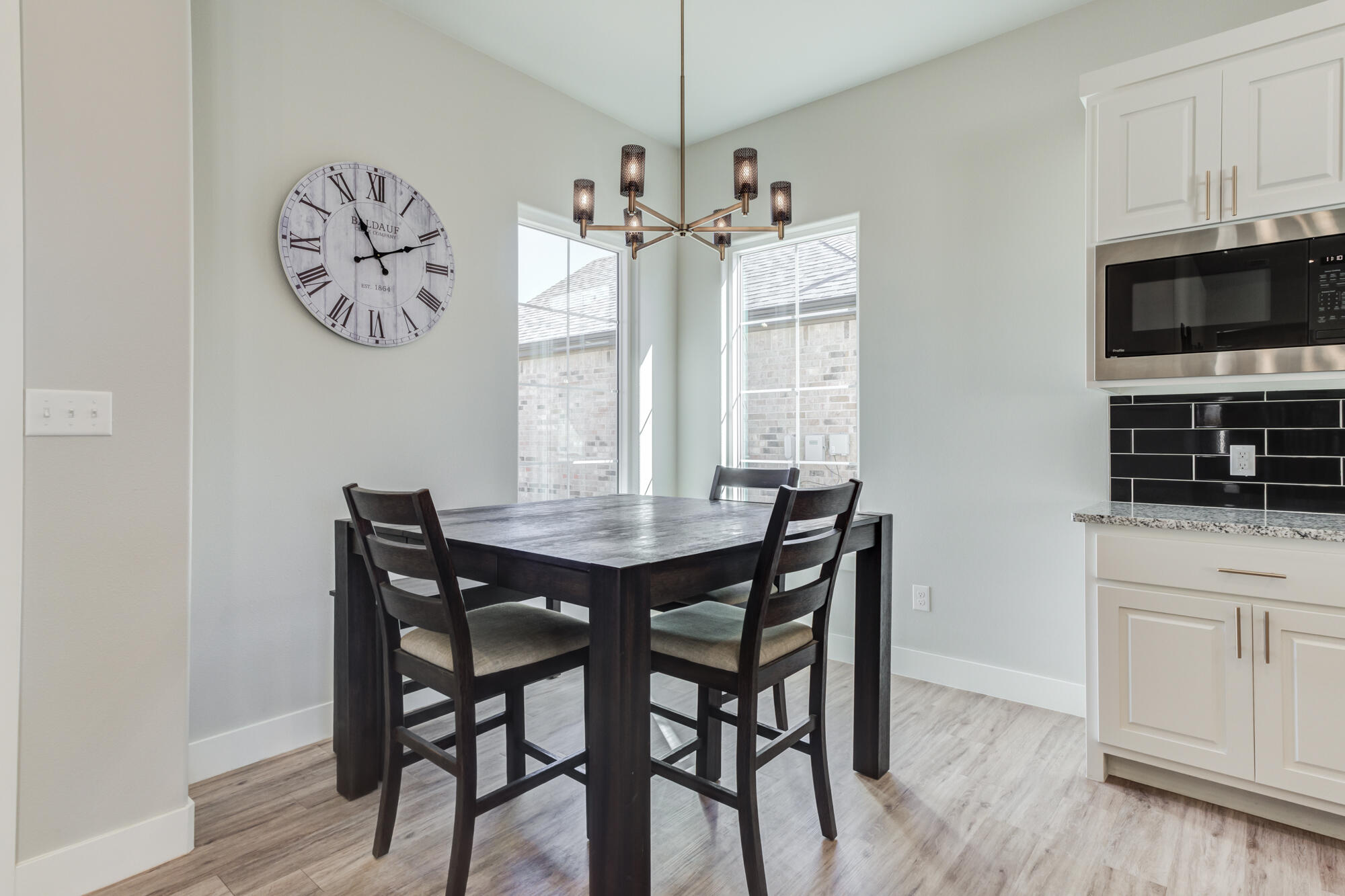 5611 117th Street Lubbock, TX 79424 - Photo 10 of 30 a view of a dining room with furniture wooden floor and a chandelier