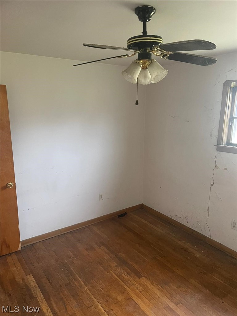 11153 Prospect Road Strongsville, OH 44149 - Photo 8 of 25 Empty room featuring dark wood-type flooring and ceiling fan
