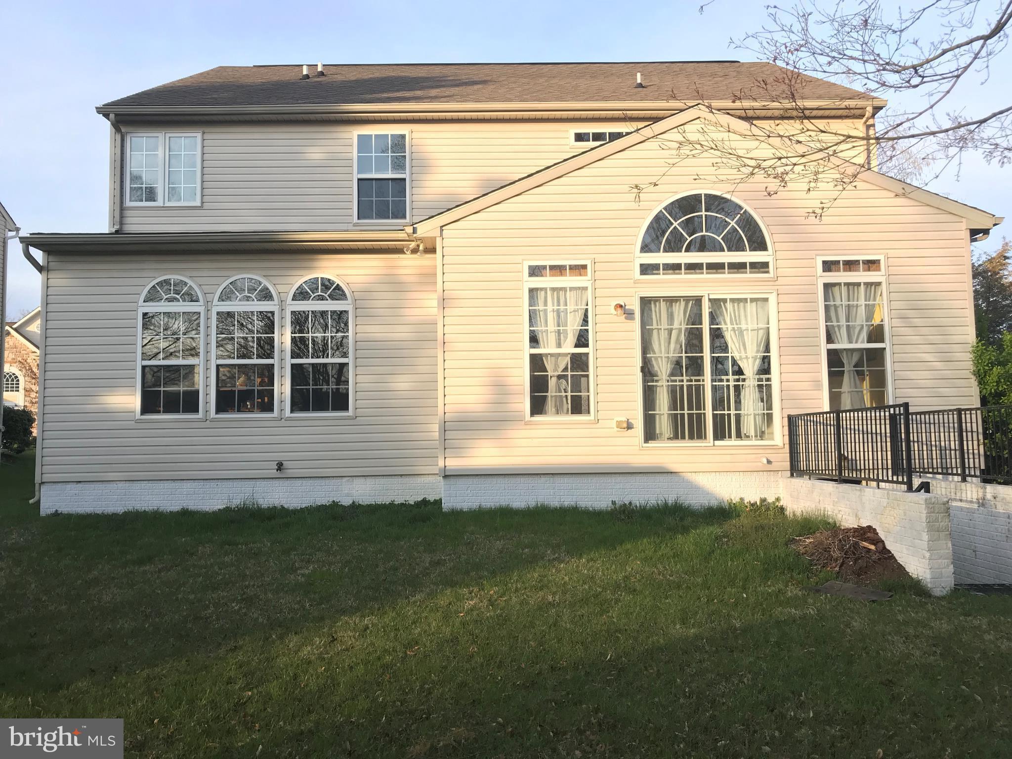 6602 Aaron Mee Way Baltimore, MD 21237 - Photo 2 of 30 a front view of a house with a garden