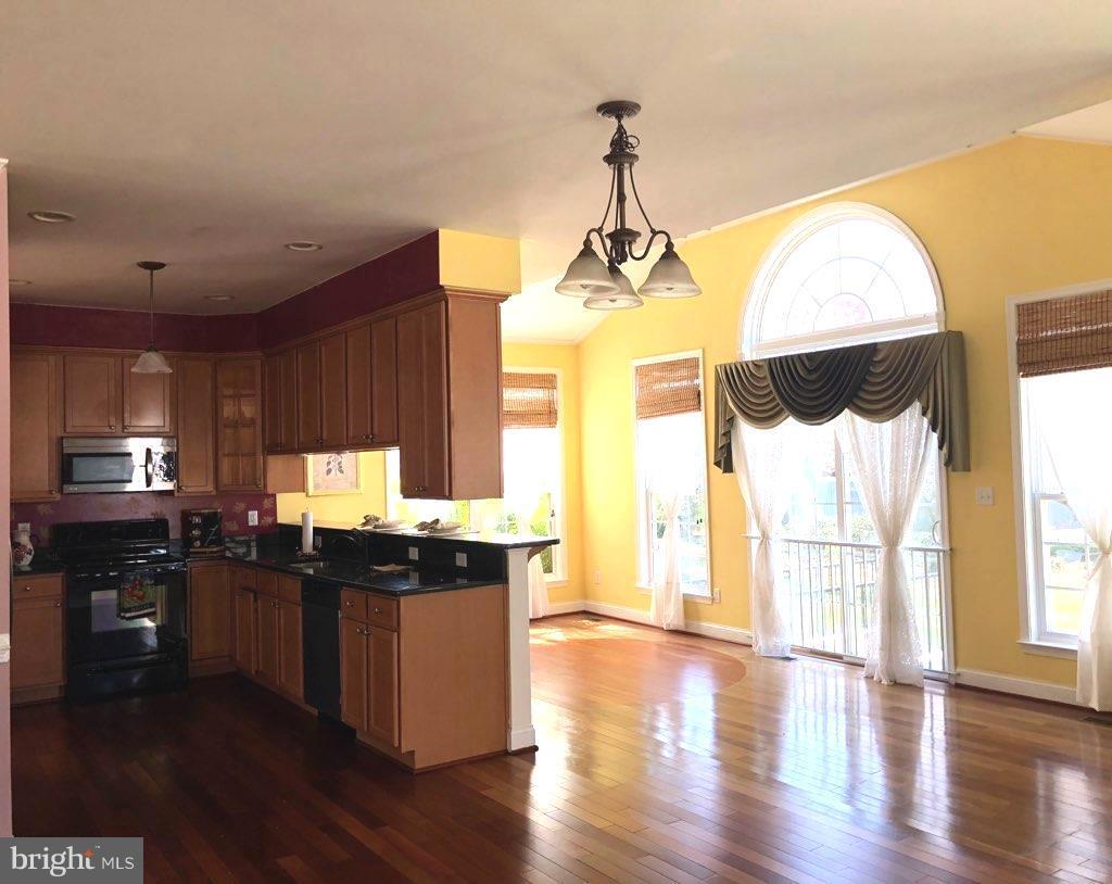 6602 Aaron Mee Way Baltimore, MD 21237 - Photo 14 of 30 a view of a kitchen with a chandelier