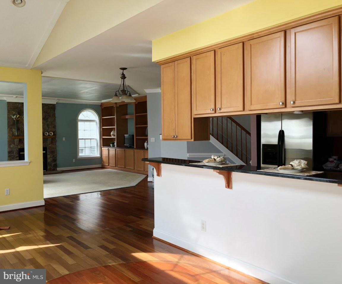 6602 Aaron Mee Way Baltimore, MD 21237 - Photo 16 of 30 a view of a kitchen with wooden floor and staircase