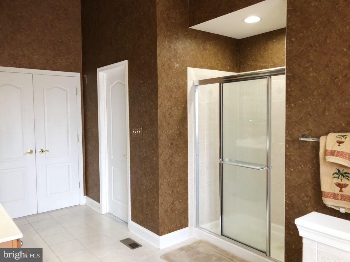 6602 Aaron Mee Way Baltimore, MD 21237 - Photo 18 of 30 a bathroom with a glass shower door