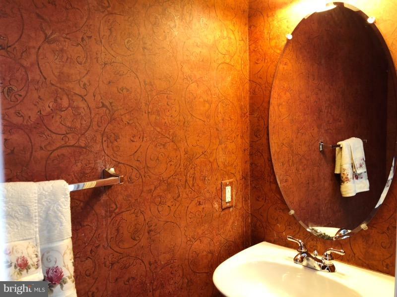 6602 Aaron Mee Way Baltimore, MD 21237 - Photo 7 of 30 a bathroom with a sink and a mirror