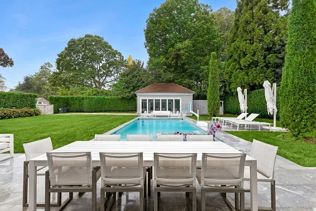 a view of house with a yard and furniture
