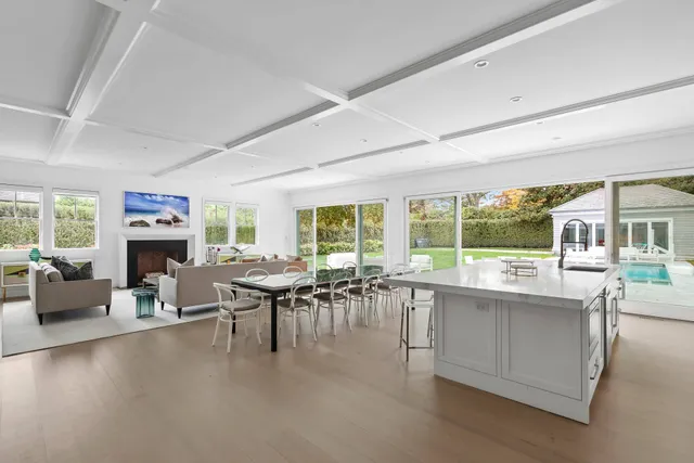 a living room with furniture a fireplace and a large window
