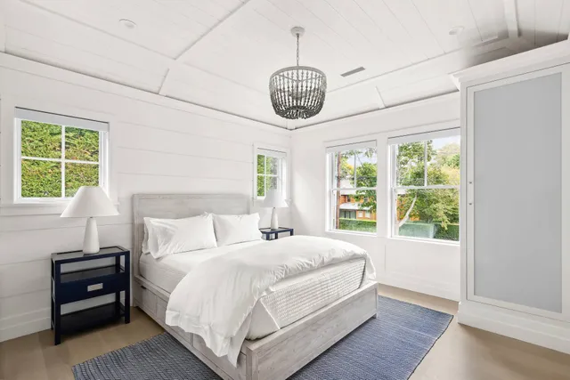 a bedroom with a large bed and a window