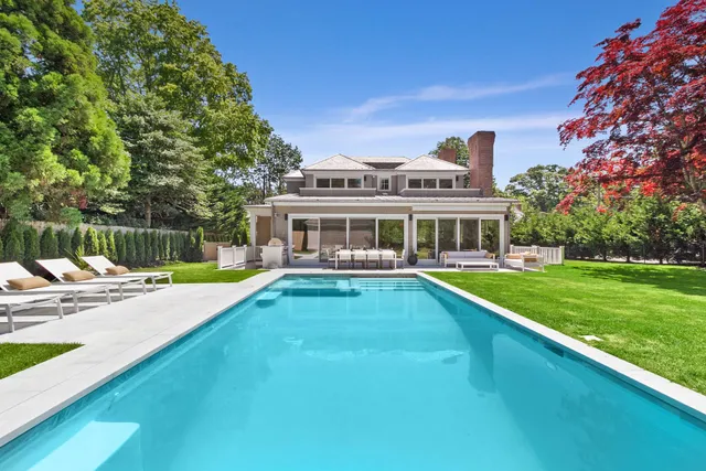 a view of an house with swimming pool and deck