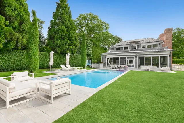 a view of a house with swimming pool and a yard