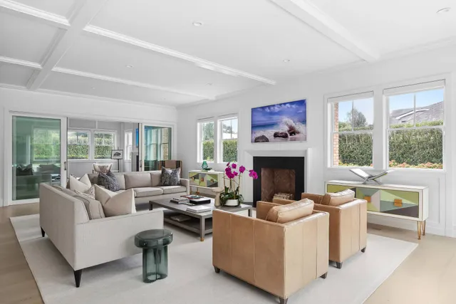 a living room with fireplace furniture and a large window