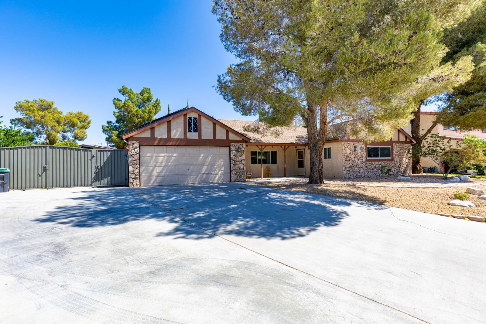 824 Kevin Way Ridgecrest, CA 93555 - Photo 6 of 38 a view of a white house with a large tree with wooden fence