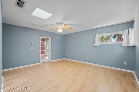 a bedroom with a bed and a potted plant