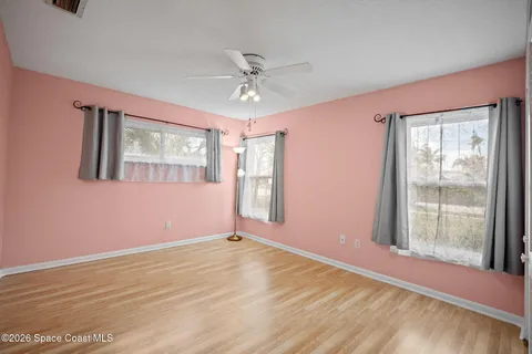a dining room with furniture and a floor to ceiling window