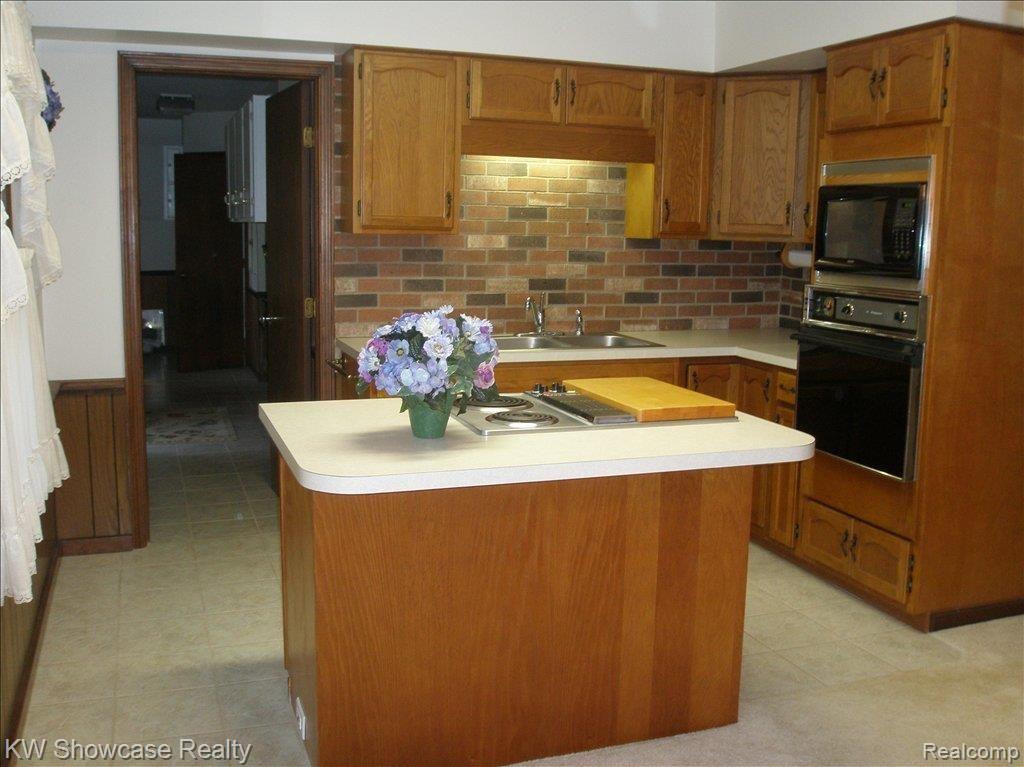 10117 Silver Lake Road Linden, MI 48451 - Photo 9 of 24 KITCHEN WITH ISLAND