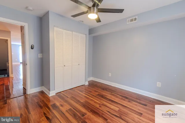 a view of empty room with wooden floor