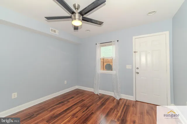 wooden floor in an empty room with a window