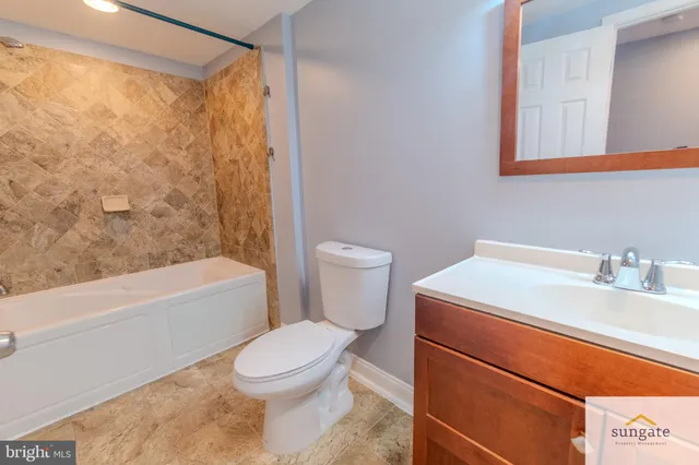 a bathroom with a sink a toilet and a bathtub