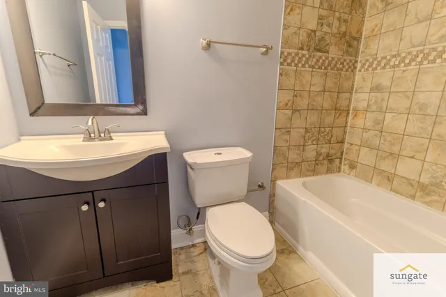 a bathroom with a sink a toilet and bathtub
