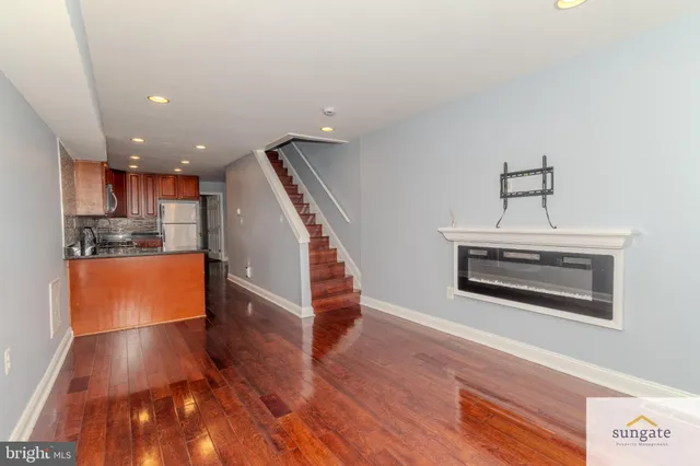 a view of kitchen with cabinets and wooden floor