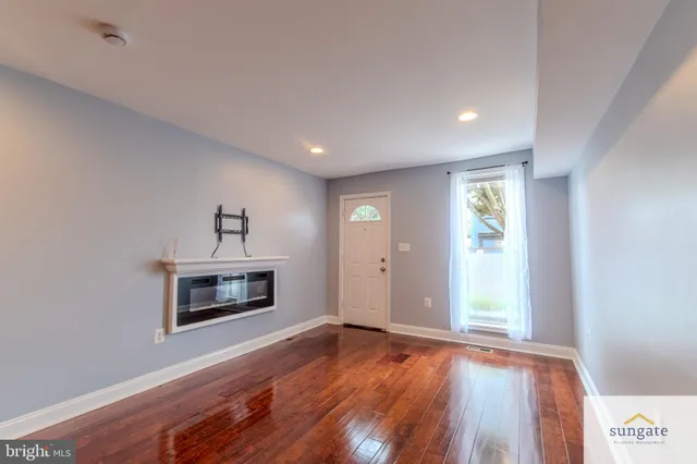 a view of empty room with window and fireplace
