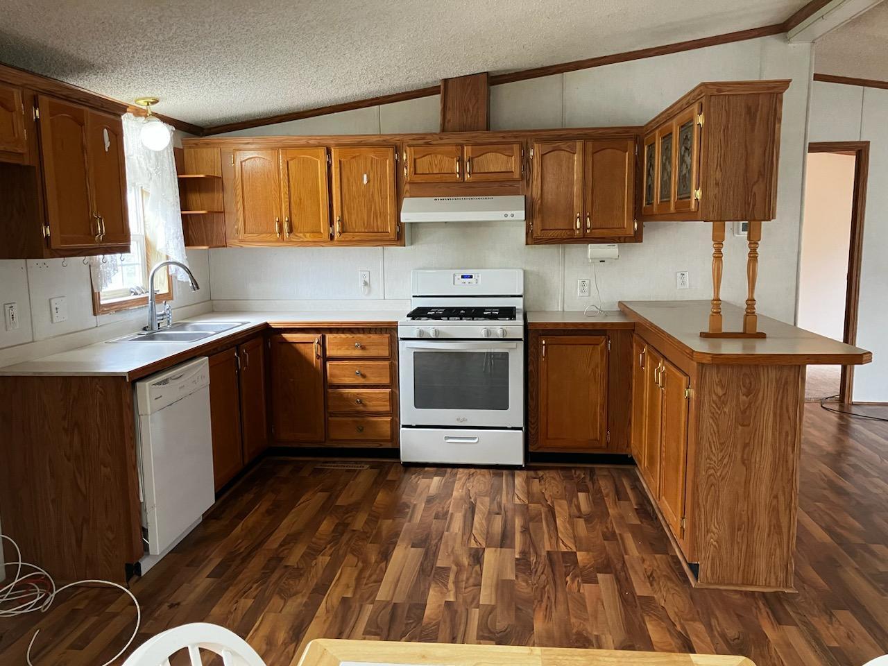 7300 South Rock Nation Road Dixon, IL 61021 - Photo 2 of 24 a kitchen with stainless steel appliances granite countertop a sink and wooden cabinets