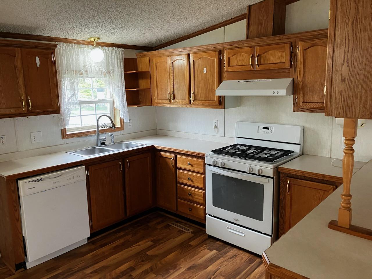 7300 South Rock Nation Road Dixon, IL 61021 - Photo 3 of 24 a kitchen with stainless steel appliances wooden cabinets and a sink