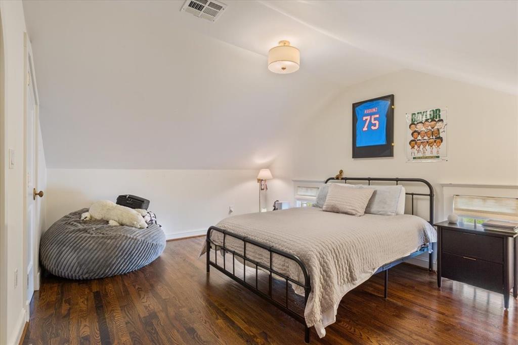 410 Rice Avenue Waco, TX 76708 - Photo 28 of 40 a bedroom with a bed and wooden floor