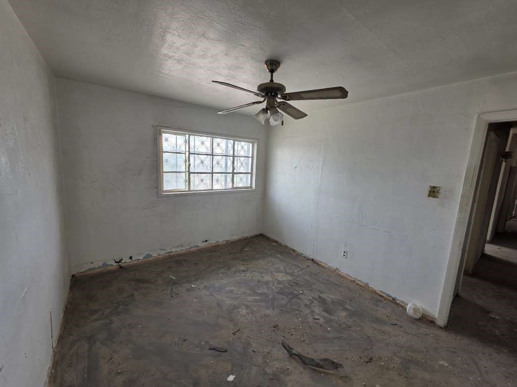 1116 Marlow Road El Paso, TX 79905 - Photo 6 of 8 an empty room with windows and fan