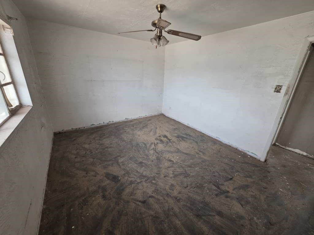 1116 Marlow Road El Paso, TX 79905 - Photo 7 of 8 an empty room with a ceiling fan and carpet